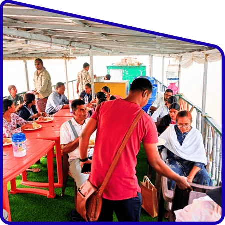 Tourists enjoying hilsa meal on boat during Sundarban Hilsa Festival Tour